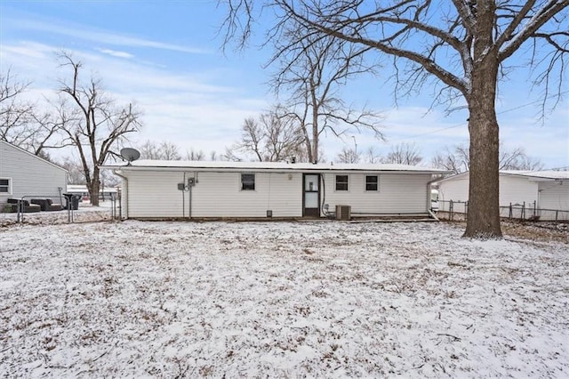 snow covered property with central air condition unit