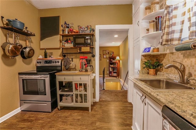 kitchen featuring open shelves, a sink, backsplash, stainless steel appliances, and dark wood-style flooring