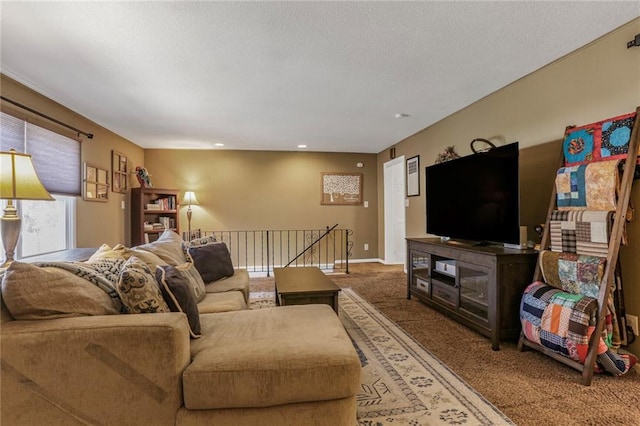 living area featuring baseboards, carpet floors, and a textured ceiling