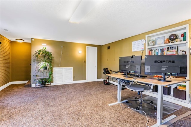 office with visible vents, a textured ceiling, baseboards, and carpet floors