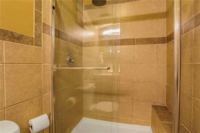 full bath with a stall shower and toilet