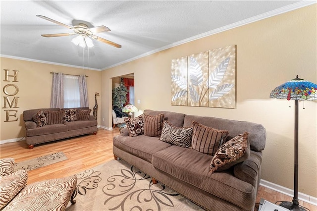 living room with a ceiling fan, crown molding, wood finished floors, and baseboards