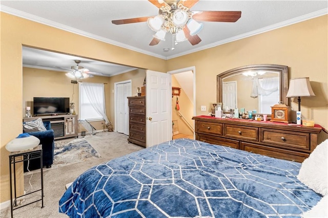 carpeted bedroom featuring ornamental molding and a ceiling fan