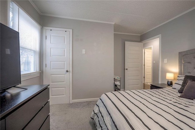 carpeted bedroom with ornamental molding and a textured ceiling