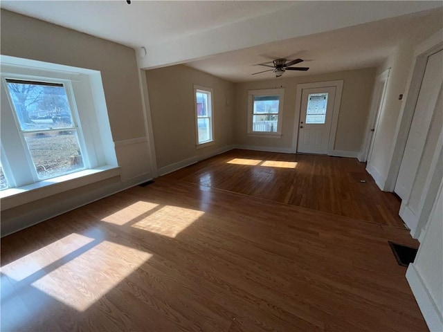 interior space with dark wood-type flooring and ceiling fan