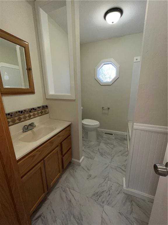 bathroom featuring vanity and toilet