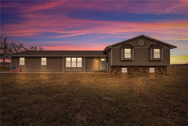 split level home featuring a yard