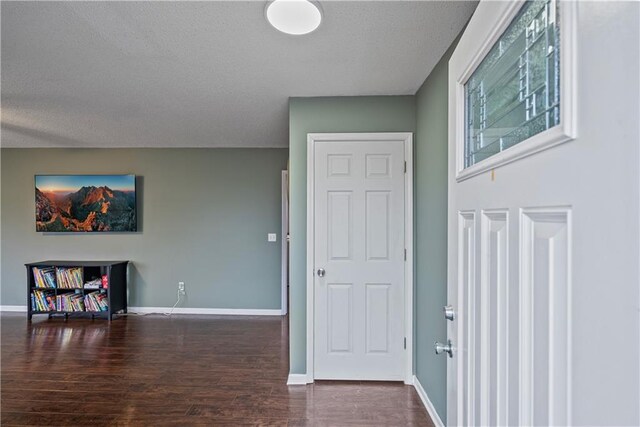 foyer entrance featuring dark hardwood / wood-style floors and a textured ceiling