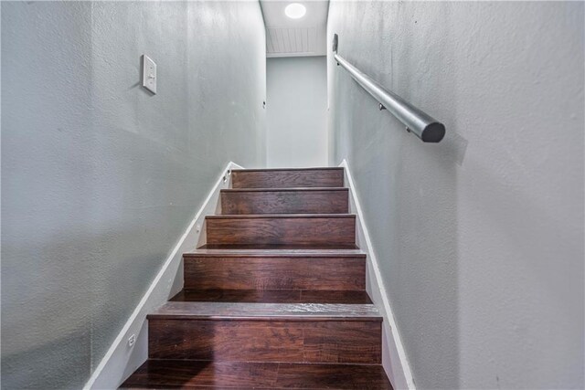 stairway with hardwood / wood-style floors