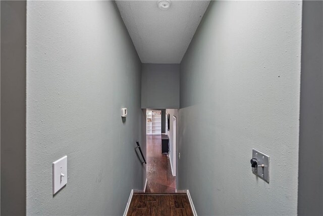 hall featuring hardwood / wood-style floors and a textured ceiling