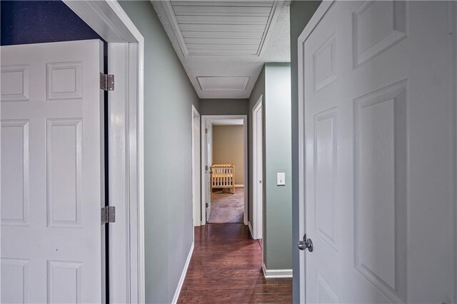 hallway with dark hardwood / wood-style flooring