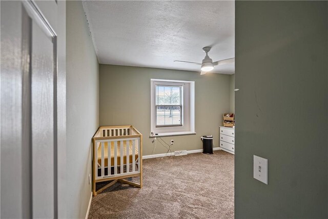 bedroom featuring ceiling fan, carpet, and a textured ceiling