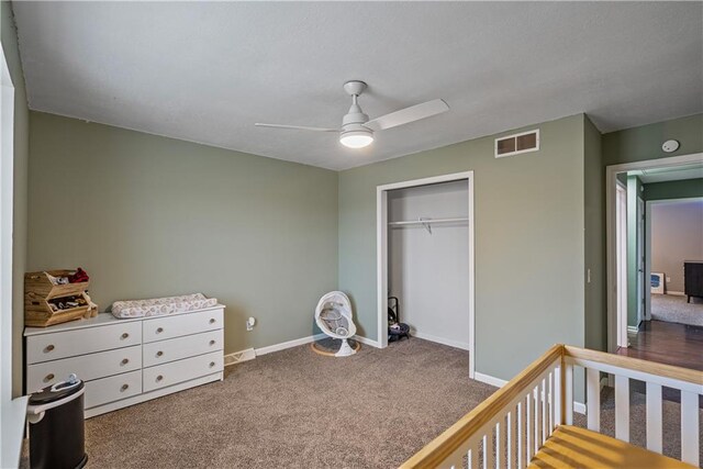 carpeted bedroom featuring ceiling fan and a closet