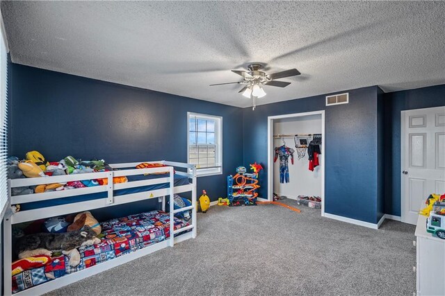 bedroom featuring ceiling fan, a closet, carpet floors, and a textured ceiling