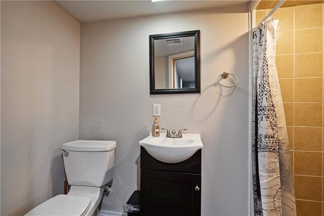 bathroom featuring vanity, toilet, and a shower with shower curtain