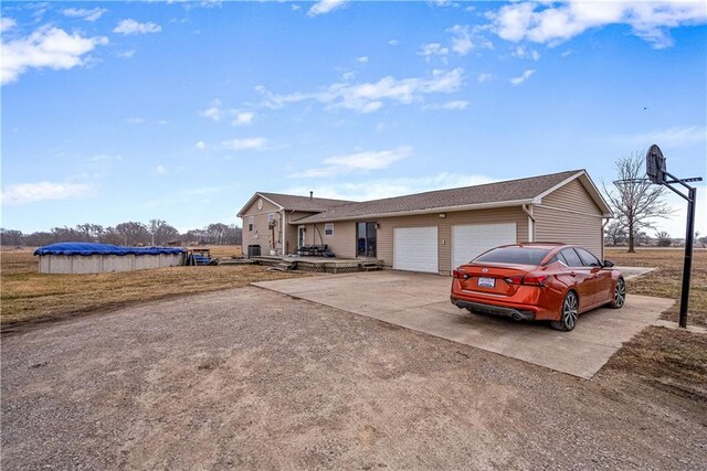 ranch-style house with a garage and a covered pool