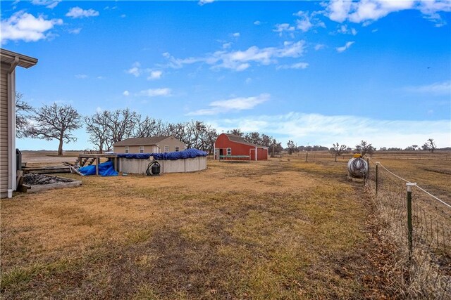 view of yard featuring a rural view and a covered pool