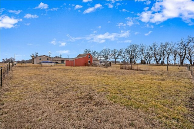 view of yard with an outbuilding and a rural view