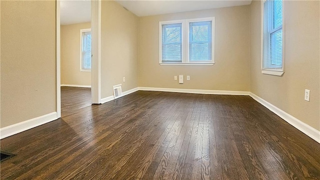 unfurnished room with dark hardwood / wood-style flooring