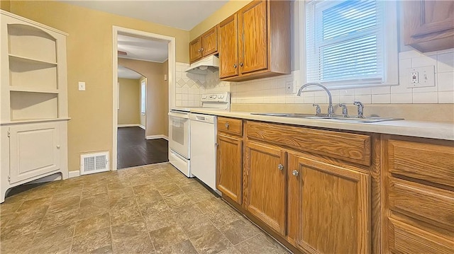 kitchen with sink, backsplash, and white appliances