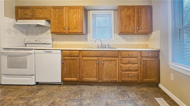 kitchen with tasteful backsplash, sink, and white appliances