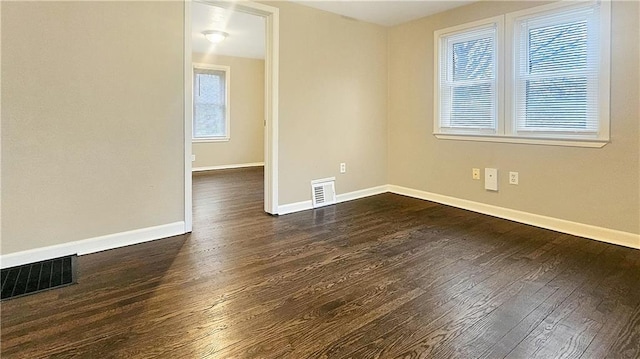 spare room featuring dark hardwood / wood-style floors