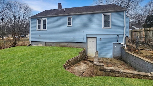 rear view of house featuring a lawn