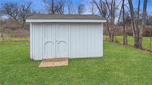 view of outbuilding with a yard