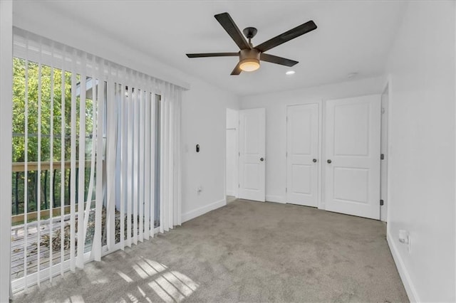 unfurnished bedroom featuring ceiling fan and light colored carpet