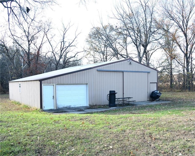 view of outbuilding with a yard and a garage