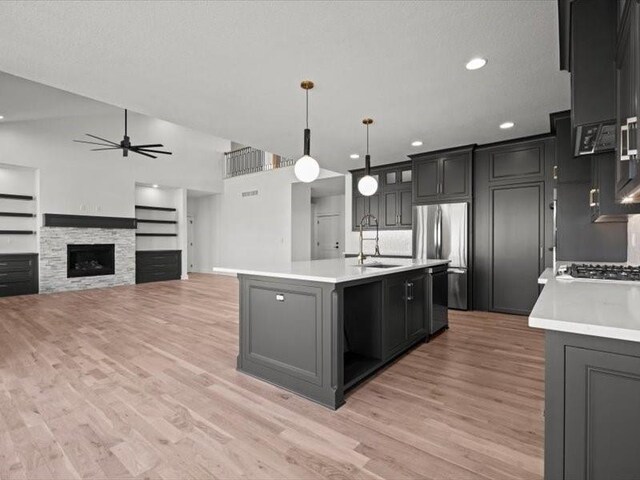 kitchen featuring ceiling fan, appliances with stainless steel finishes, light countertops, and a sink