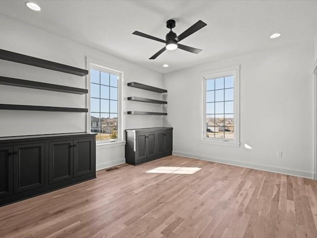 interior space featuring a ceiling fan, recessed lighting, light wood-style flooring, and baseboards