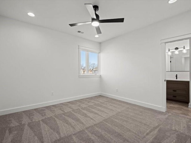 unfurnished bedroom featuring carpet, recessed lighting, visible vents, ensuite bath, and baseboards