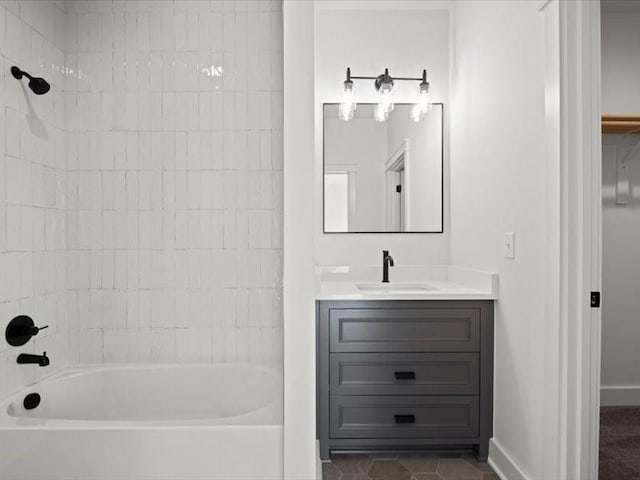 bathroom with bathing tub / shower combination, tile patterned flooring, vanity, and baseboards