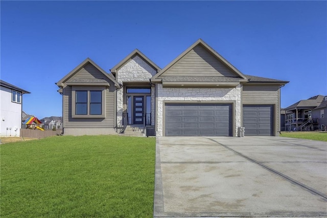 view of front of home with a garage and a front lawn