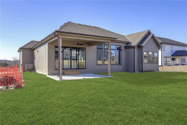 back of property with ceiling fan, a patio area, and a lawn