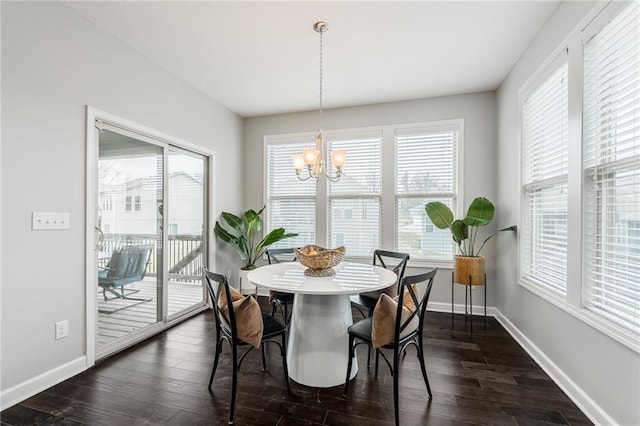 dining space with dark wood-style floors, baseboards, and a notable chandelier