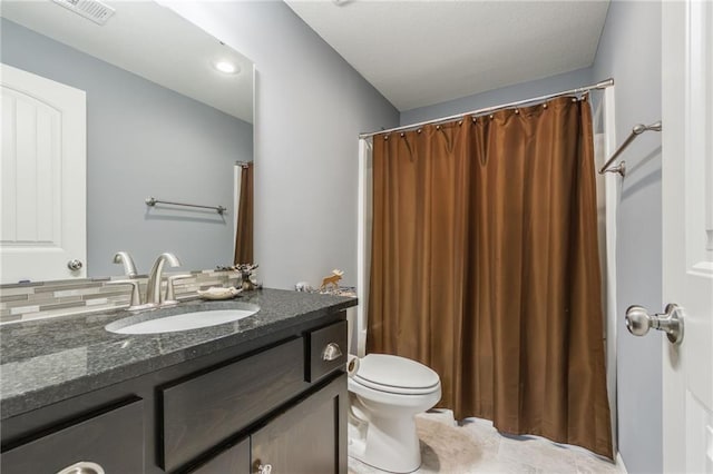 bathroom with toilet, visible vents, and vanity