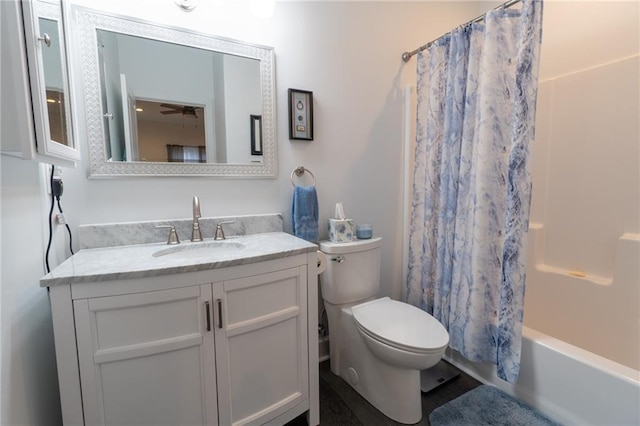 full bathroom with shower / bath combo, vanity, and toilet