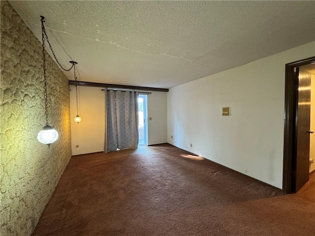 spare room with carpet floors and a textured ceiling