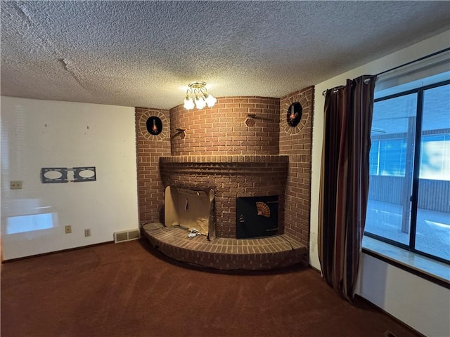 unfurnished living room with a fireplace, carpet floors, and a textured ceiling