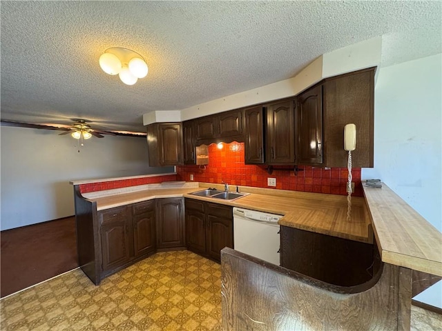 kitchen with sink, white dishwasher, dark brown cabinetry, decorative backsplash, and kitchen peninsula