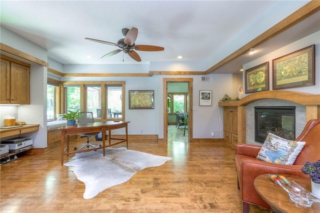 18402 W 64th St, Shawnee, KS 66218 - home office featuring a glass covered fireplace, light wood-style floors, ceiling fan, baseboards, and recessed lighting