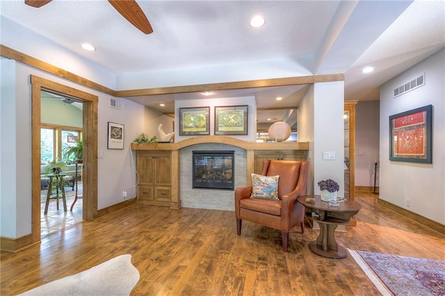 18402 W 64th St, Shawnee, KS 66218 - sitting room with a ceiling fan, a multi sided fireplace, wood finished floors, recessed lighting, and baseboards