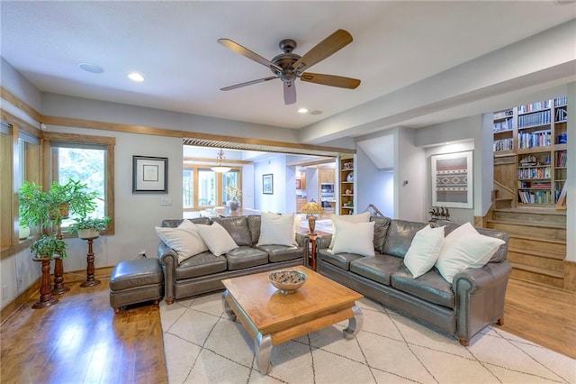 18402 W 64th St, Shawnee, KS 66218 - living area featuring light wood-style flooring, ceiling fan, recessed lighting, built in shelves, and stairway