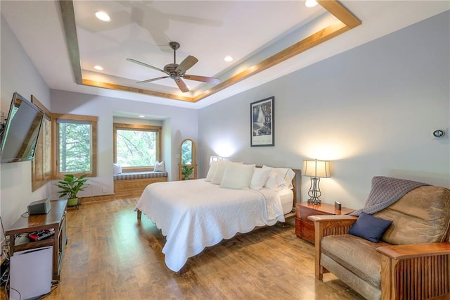 18402 W 64th St, Shawnee, KS 66218 - bedroom with a tray ceiling, wood finished floors, recessed lighting, and ceiling fan