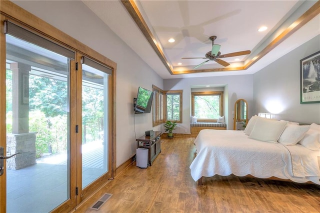 18402 W 64th St, Shawnee, KS 66218 - bedroom with a tray ceiling, access to outside, light wood-style flooring, recessed lighting, and baseboards