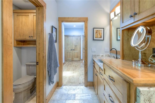 18402 W 64th St, Shawnee, KS 66218 - bathroom featuring baseboards, vanity, and toilet