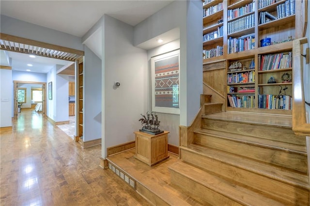 18402 W 64th St, Shawnee, KS 66218 - corridor featuring wood finished floors, baseboards, and stairway