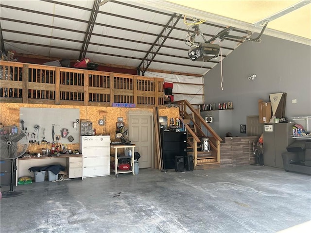 garage with a workshop area and a garage door opener